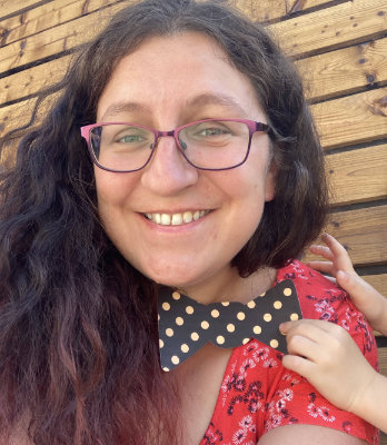 Graphic designer relaxing outdoors with family, enjoying a sunny and peaceful moment together.