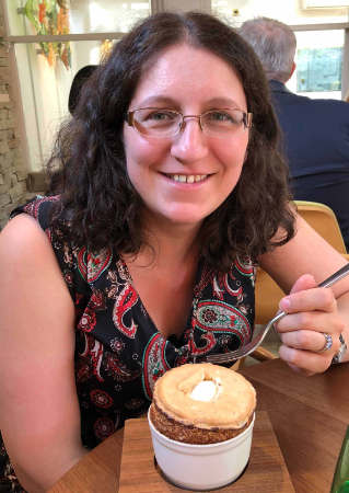 Female graphic designer relaxing at a restaurant during a lunch date.