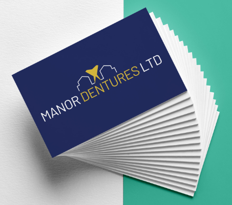 Dental business card with Manor Dentures branding design.
